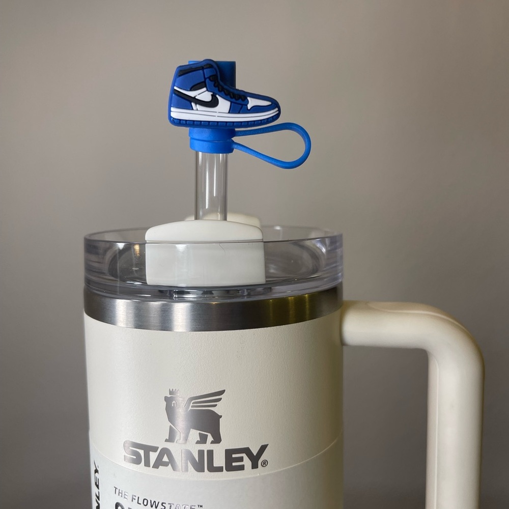 3 blue, 2 red, one pink and black Stanley topper